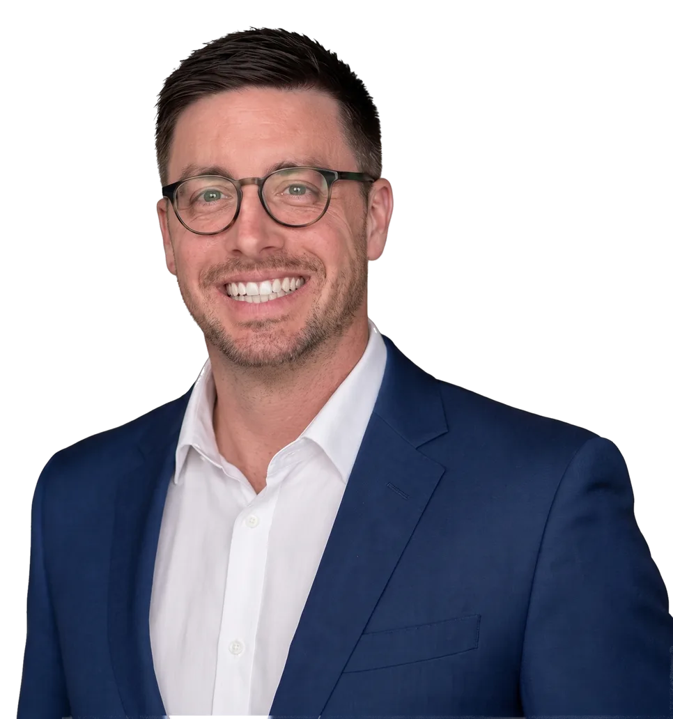Stephen Thorn smiling, in a navy blazer and white shirt